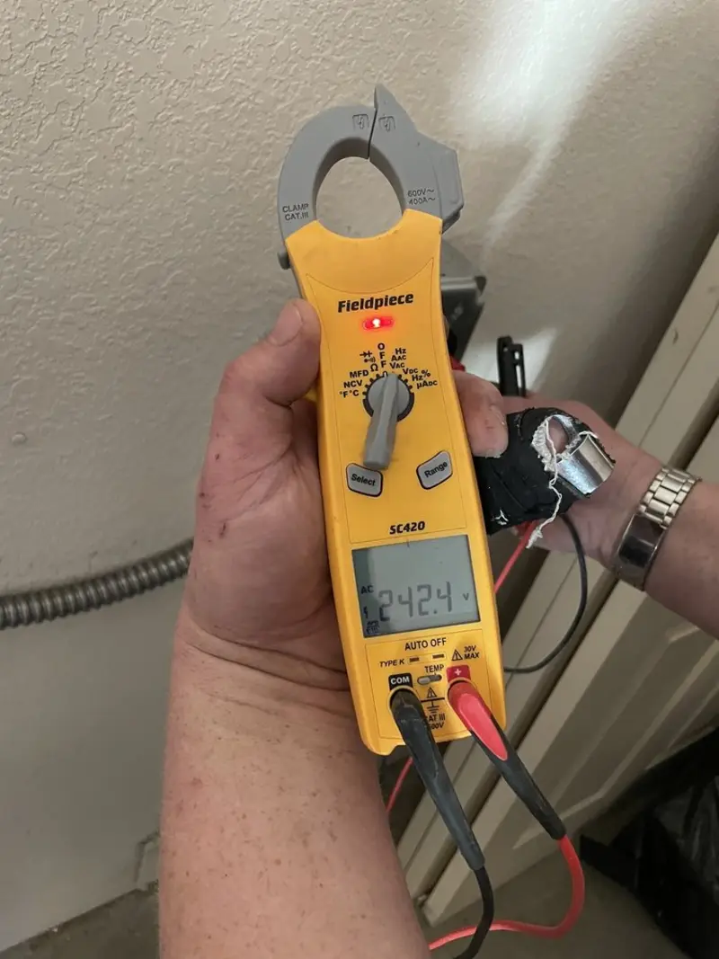 Voltage testing with clamp meter during Recessed Lighting Installation in Oakton